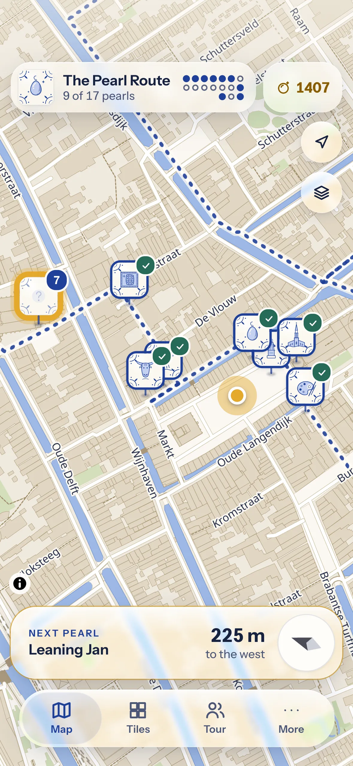 L’app Perle di Delft: una mappa del centro storico con le perle come segnaposto e, in basso, una bussola che indica la perla successiva.